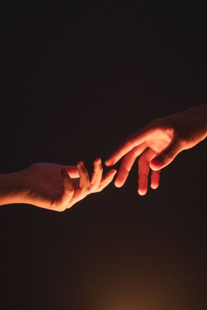 Poem on love image of hands wanting to hold each other 
