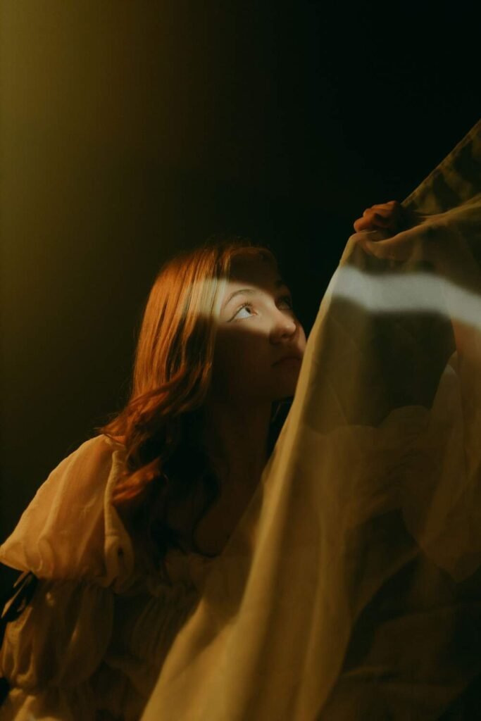 poem on heartbreak woman gazing through curtain light
