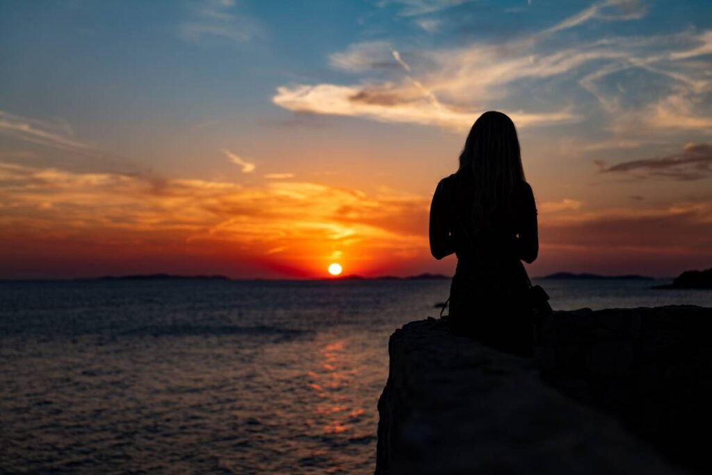 : unattainable love poem woman waiting alone at sunset