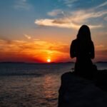 : unattainable love poem woman waiting alone at sunset