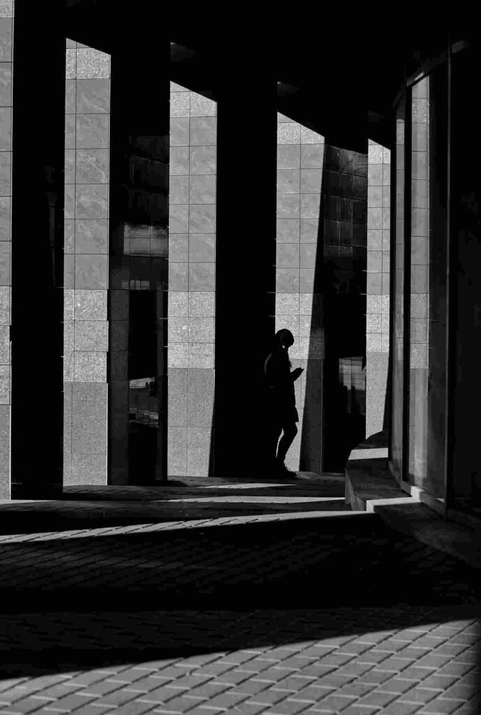 Silhouette of a woman walking toward the light, symbolizing moving on from heartbreak
