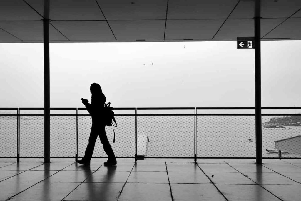 Woman walking alone by the water, a quiet moment of moving on from heartbreak