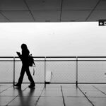 Woman walking alone by the water, a quiet moment of moving on from heartbreak
