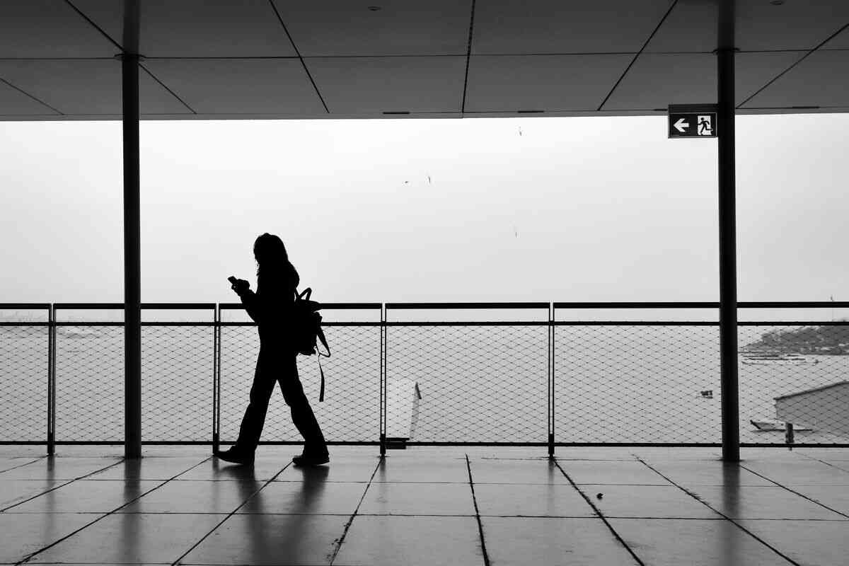 Woman walking alone by the water, a quiet moment of moving on from heartbreak