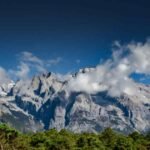 Poem inspired by The Untamed, lone figure in white robes on a misty mountain path